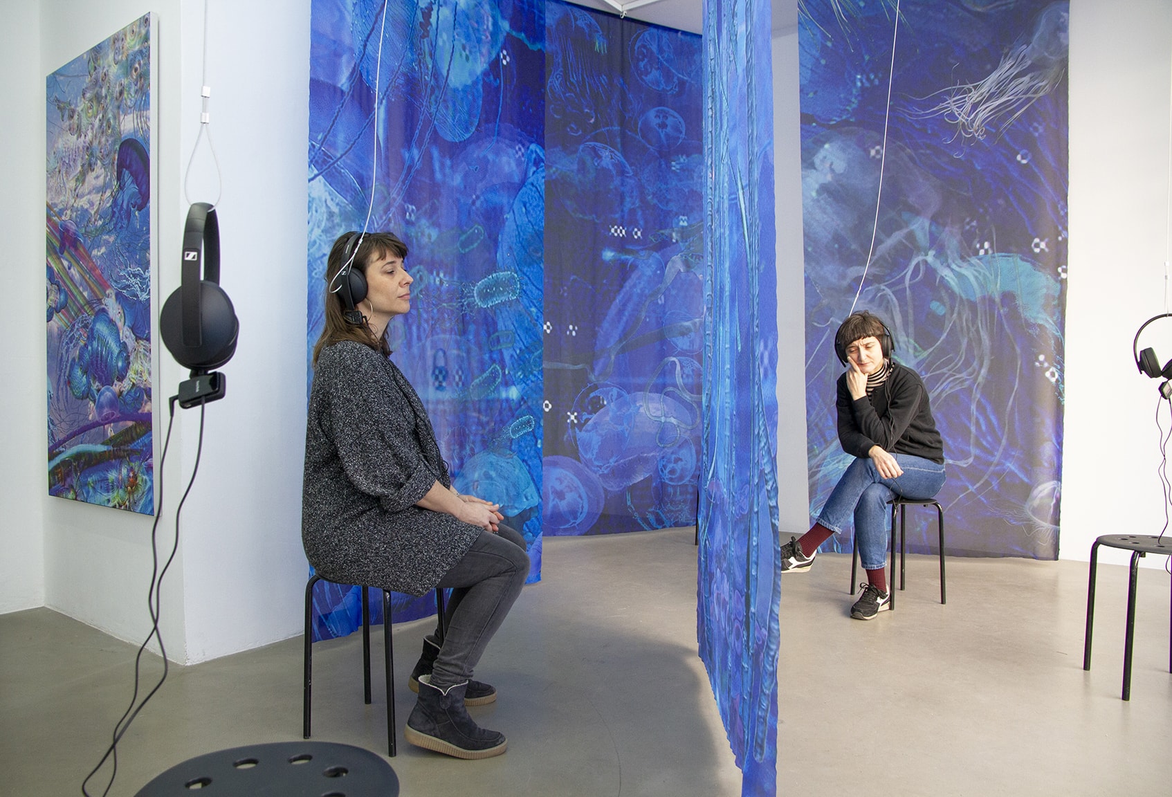 Visitors in the Einen Riesigen Schwarm immersive installation - large format textile banners, sound installation, digital prints